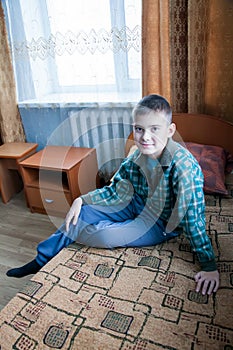 Boy sits on a bed