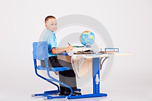 Boy sits at his desk and doing homework