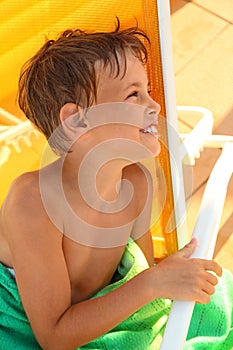 Boy sits in yellow deck chair