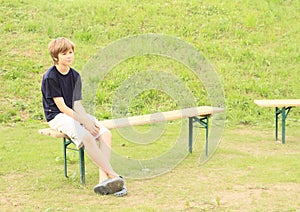 Boy sitting on bench