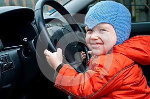 Boy sitting in the car as the driver