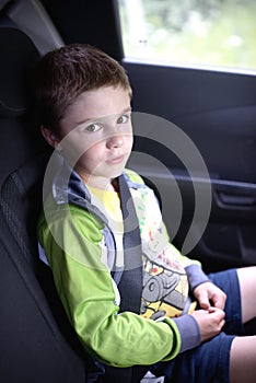 Boy sitting in car safety chair