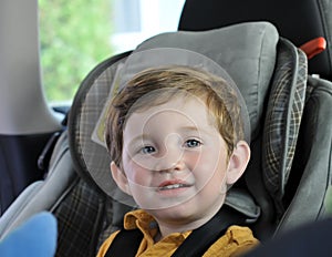 Boy sitting in child car seat