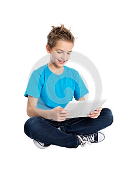 Boy sitting with digital tablet