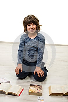 Boy sitting down and reading books