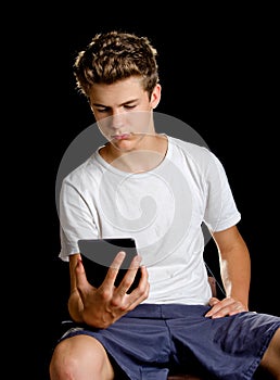 Boy sitting with ebook reader or tablet in his hand