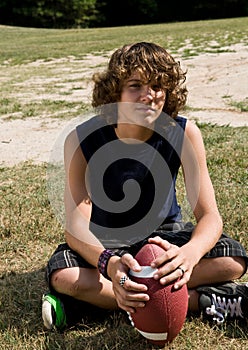 Boy sitting with football