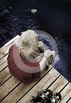 Boy sitting on a Footbridge alone photo