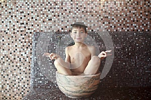 Boy sitting in hammam