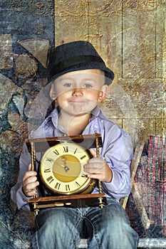Boy sitting holding clocks in the hands of a waiting midnight