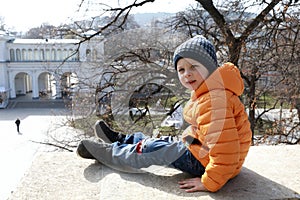 Boy sitting on Lermontov site wall