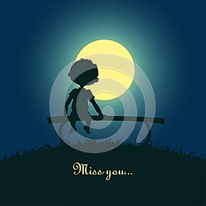 Boy sitting lonely in the moonlight photo