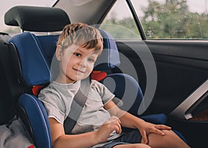 Boy sitting in safety car seat