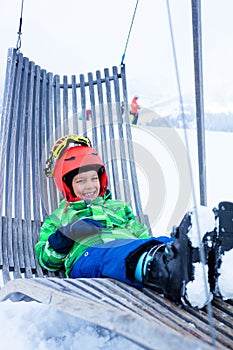 Boy sitting in sun lounger and resting