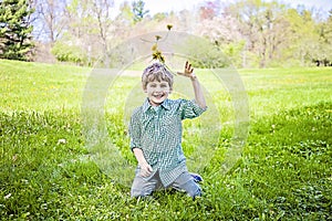 Boy sitting tossing up fresh picked flowers