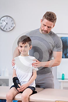 Boy sitting on treatment table