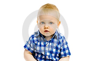 Boy sitting on a white background