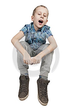 Boy sitting on white middle