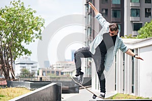 Boy skater is doing stunt at the street