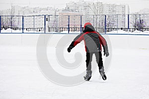 Boy skating rear view
