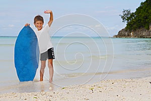 Boy with skim board on sea background