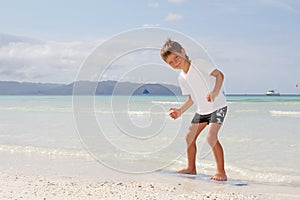 Boy with skim board on sea background photo