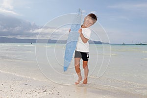 Boy with skim board on sea background