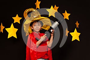 Boy in sky watcher costume with telescope