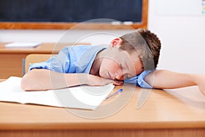 Boy sleeping in classroom