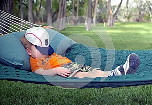 Boy sleeping in hammock photo