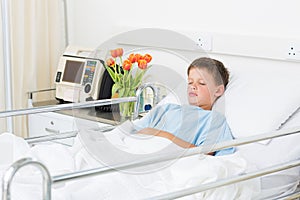 Boy sleeping in hospital ward