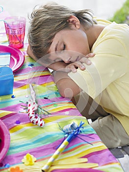 Boy Sleeping At Table After Birthday Party