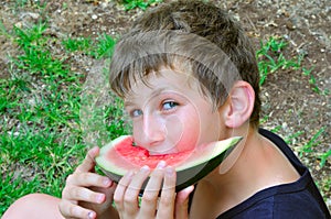 A boy with a slice of watermelon