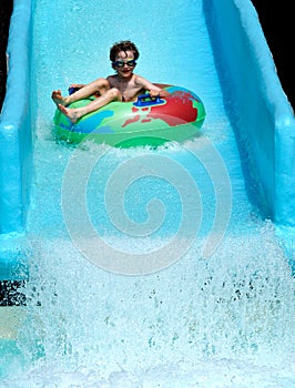 Boy on slide at waterpark photo