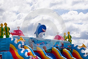 Boy sliding down an inflatable Side . Russia Berezniki 26 may 2019