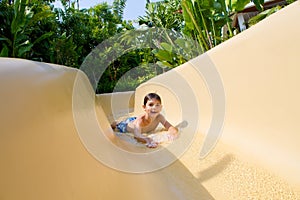 Boy Sliding Down Water Slide.