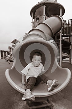 Boy sliding on playground