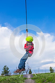 Boy sliding on zip line