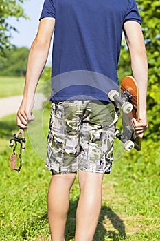 Boy with a slingshot and skateboard