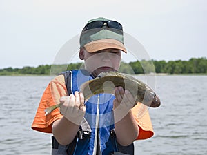 Boy with slippery fish photo