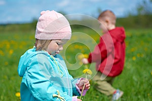 Boy and small girl on meadow