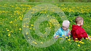 Boy and small girl on meadow