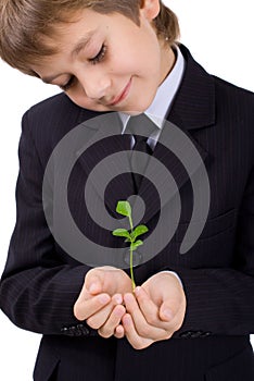 Boy with a small green plant