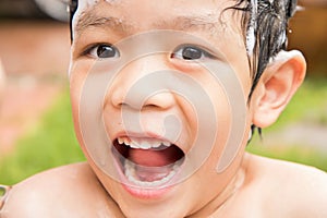 Boy smile and laugh when he enjoy and happy on his bath time