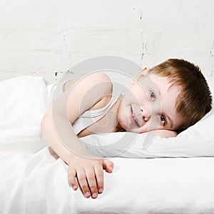 Boy smiling in bed