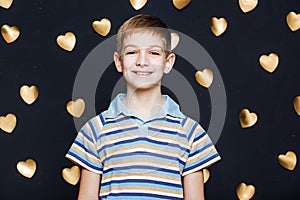 Boy smiling on golden hearts background