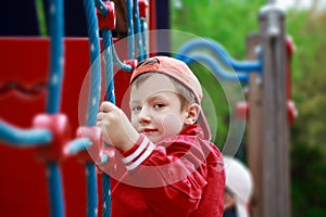 Boy smiling at jungle gym