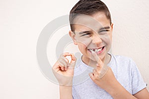 boy showing his lost milk tooth, close up