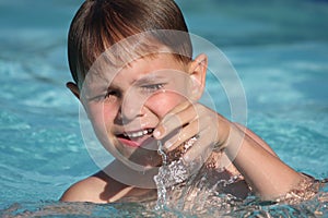 Boy smiling in swimming pool