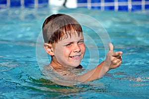 Boy smiling in swimming pool